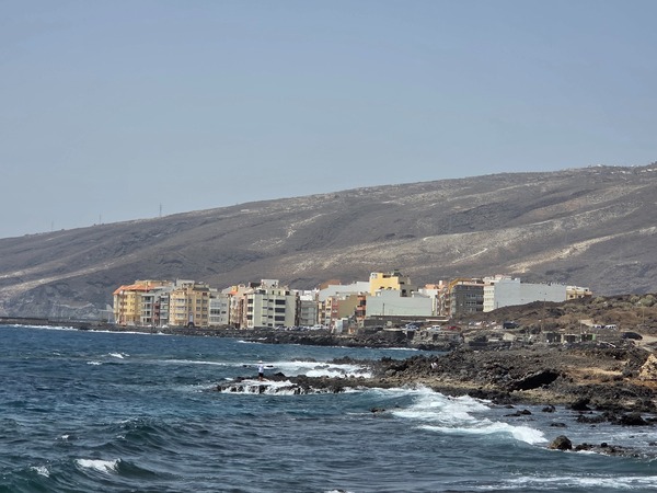 Distant view of the coastal town of Puertito de Güímar from the lava shoreline of the reserve.
