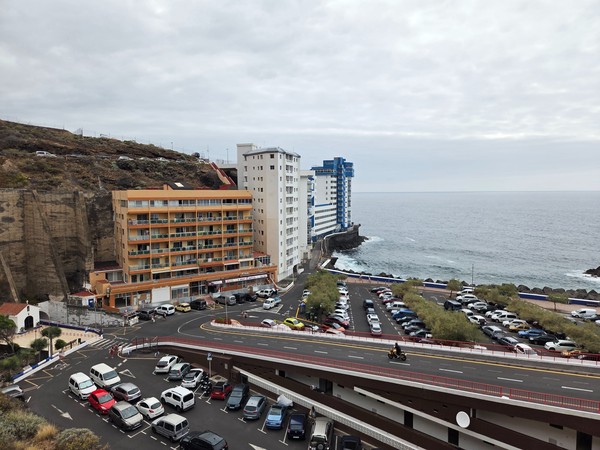 Seafront buildings and large car parks beside the Atlantic at Mesa del Mar, Tacoronte.