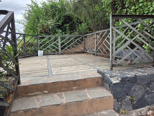 Wooden lookout platform with railings set among trees on the cliff route Wooden lookout platform with railings set among trees on the cliff route.