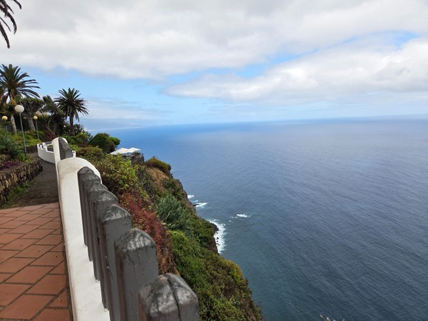 Cliff-edge walkway with handrail overlooking the open Atlantic Ocean from Mirador de La Garañona in El Sauzal.