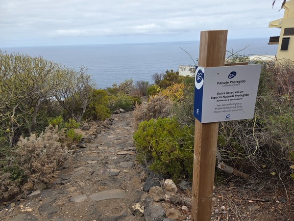 Marker at the entrance to the Costa de Acentejo Protected Landscape asking visitors to help conserve the area.