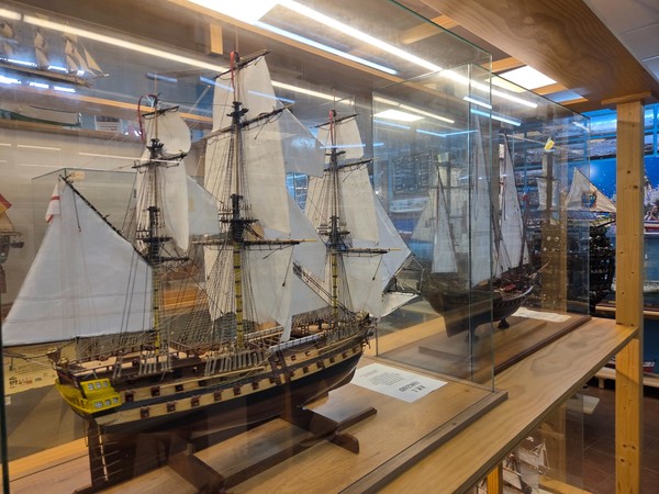 Detailed scale models of three-masted sailing ships displayed in glass cabinets inside the Fisherman’s Museum of Puerto de la Cruz.