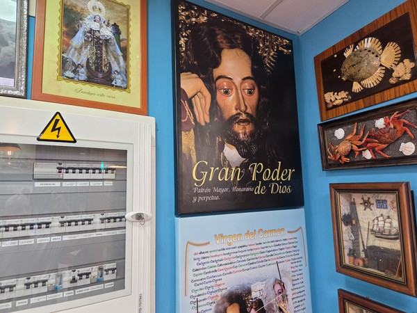 Museum corner with the banner “Gran Poder de Dios” and a panel about the Virgen del Carmen, alongside marine specimens.