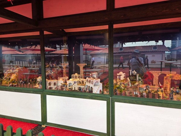 Glass-fronted nativity scene with miniature houses, bridges and figures as part of the Christmas decorations at El Corte Inglés Tenerife.