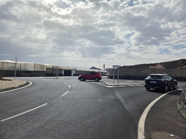 Billboard at the entrance of Palm-Mar advertising real estate with the text about finding your piece of paradise.