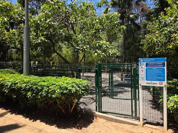 Dog park entrance with sign and fenced area