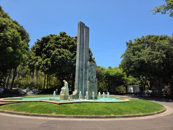 Central fountain with tall monument and statue