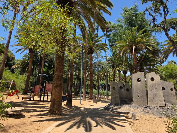 Play area with modern installations and stone sculpture