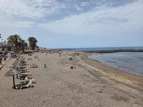Wide view of Playa El Bobo with loungers and umbrellas