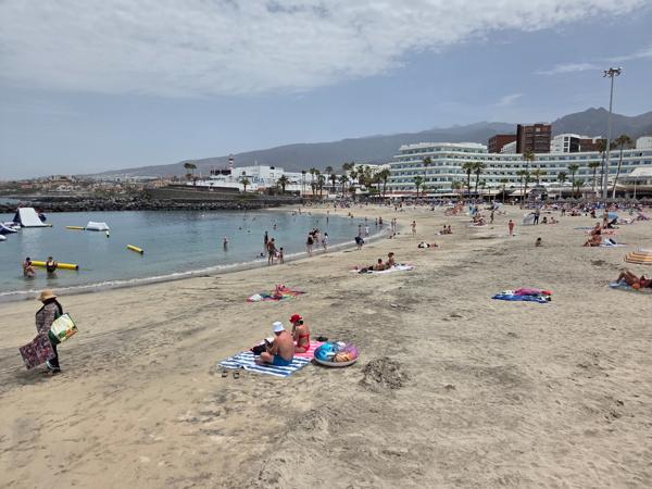 Visitors enjoying the sun on the sand and in the water