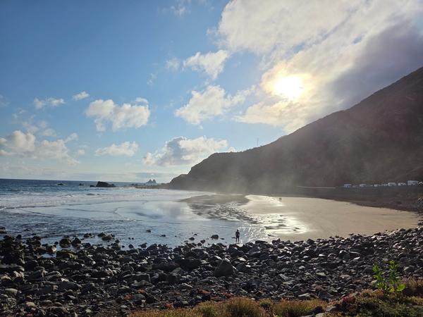Golden sunlight over Playa de Almáciga with mist rising from the sand.