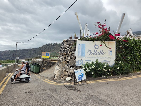 Entrance sign for Bollullo Restaurant & Beach next to the small cliff-edge parking area.
