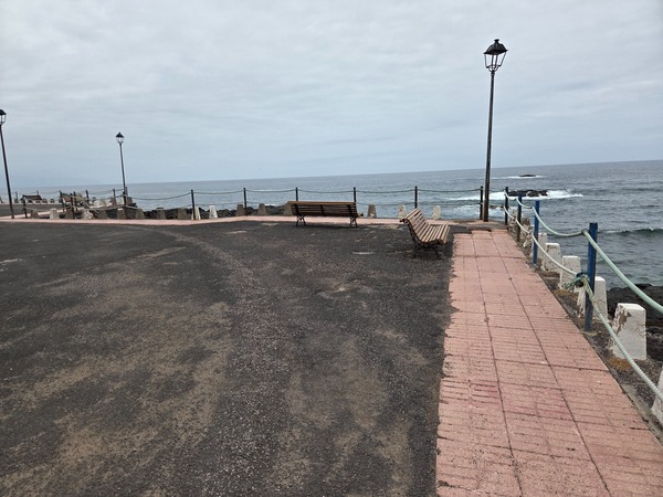 Seafront promenade between Playa de la Arena and Mesa del Mar with benches and lampposts overlooking the Atlantic.
