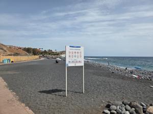 Entrance sign at Playa de la Enramada with beach rules