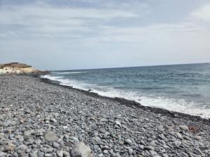 Pebble-covered shoreline with Atlantic waves