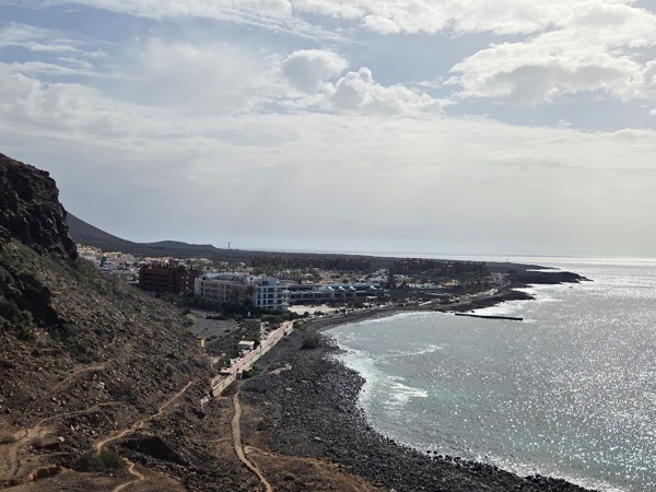 Panoramic view of Playa La Arenita in Palm-Mar with apartments and hotels lining the rocky coastline of southern Tenerife.