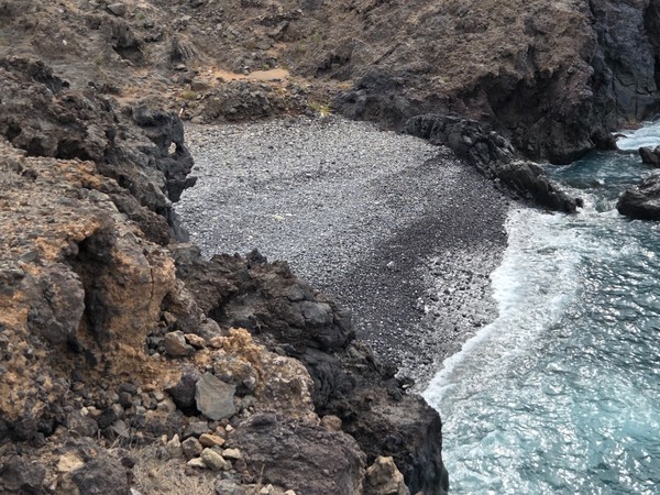 Elevated view toward the Ricasa shoreline with cliffs and cultivated terraces descending to the Atlantic.
