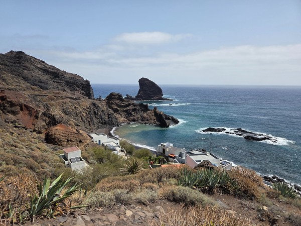 Panoramic view of Playa de Roque Bermejo cove and its tiny hamlet on Tenerife’s Anaga coast, with the offshore rock and turquoise water.
