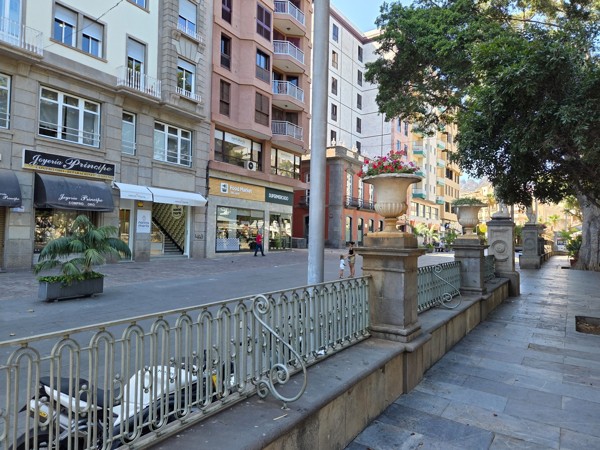 Facade of shops and businesses along the edge of Plaza del Príncipe de Asturias.