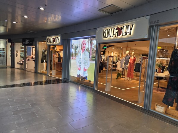 Koala Bay store with light dresses and resortwear on display.
