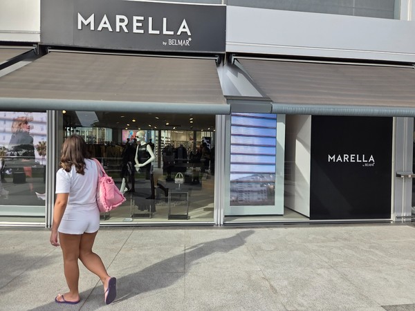 Marella by Belmar storefront with mannequins and digital displays.
