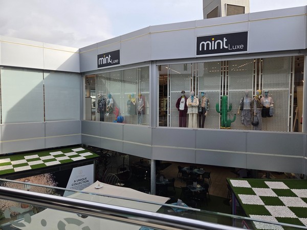 Mint Luxe façade with mannequins, décor props and a cactus feature above the atrium.