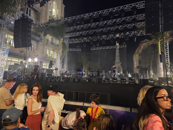 Main stage set up between palm trees on a city square in Santa Cruz de Tenerife before a Plenilunio concert begins.