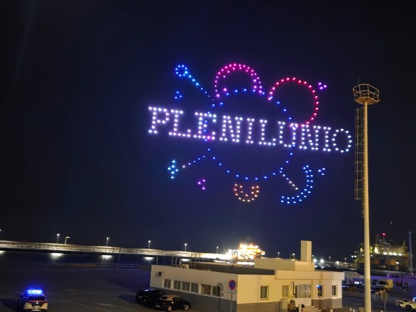 Finale of the drone show with the word PLENILUNIO written in lights over the sea at Santa Cruz de Tenerife.