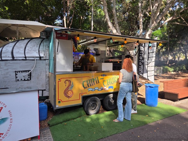 Chimi-churri grill trailer where skewers sizzle over hot coals. Taken at Plenilunio 2025 in García Sanabria Park, Santa Cruz de Tenerife.