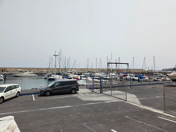 Marina of El Puertito de Güímar with yachts and moorings protected by the breakwater.