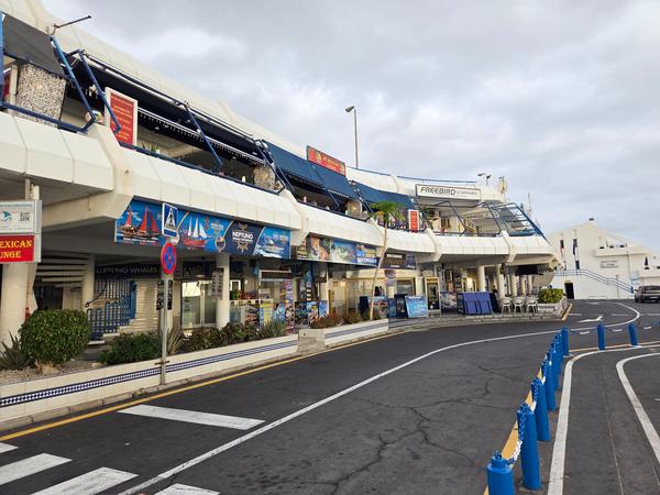 Shops at Puerto Colón offering excursions, boat trips, and whale watching tours