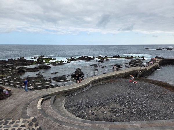 Lava rocks and a curved platform leading into tidal pools on the Atlantic coast of Puerto de la Cruz.