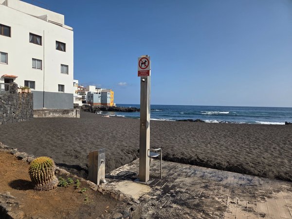 Outdoor stainless-steel shower for rinsing off sand at Punta Brava Beach.