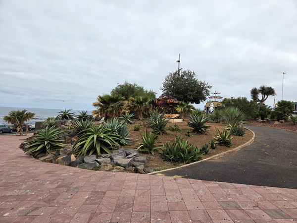 Succulent garden and coastal-themed sculptures near the seafront at Punta del Hidalgo.