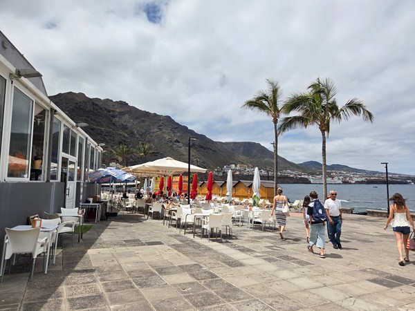 Restaurant terrace on the promenade of Punta del Hidalgo with ocean views.