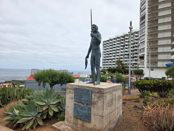 Sculpture of a Guanche fisherman holding a fish in Punta del Hidalgo.