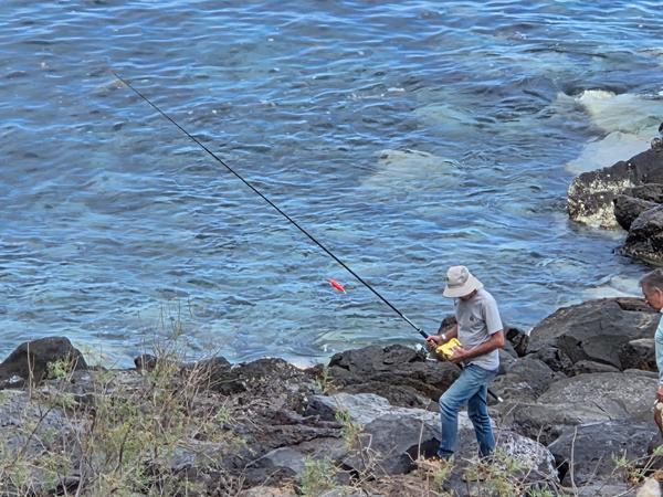 Local men fishing on coastal rocks in Radazul Bajo.