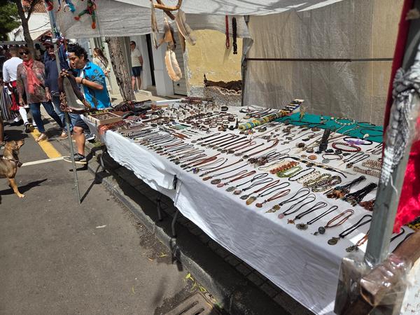 Market stand with handmade jewelry, necklaces, and crafts at the festival.