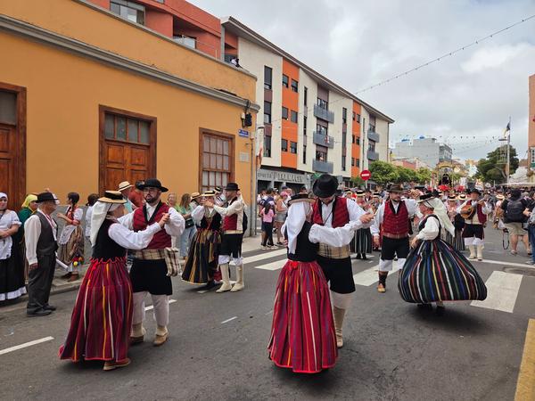 Couples performing traditional Canarian dances in vibrant costumes.