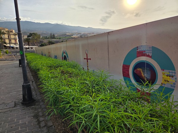 Colorful maritime mural with lifebuoy motif on a wall close to the promenade in Playa San Juan.