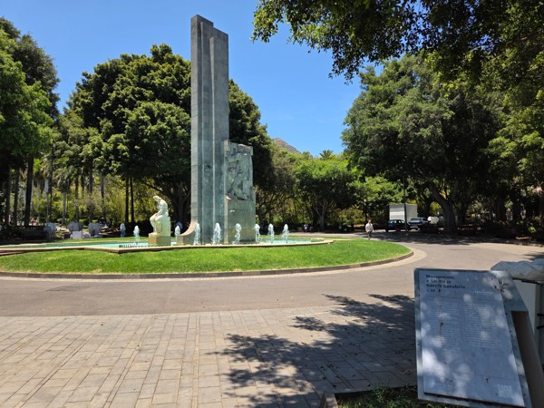 Central fountain and tall trees at García Sanabria Park in Santa Cruz de Tenerife.