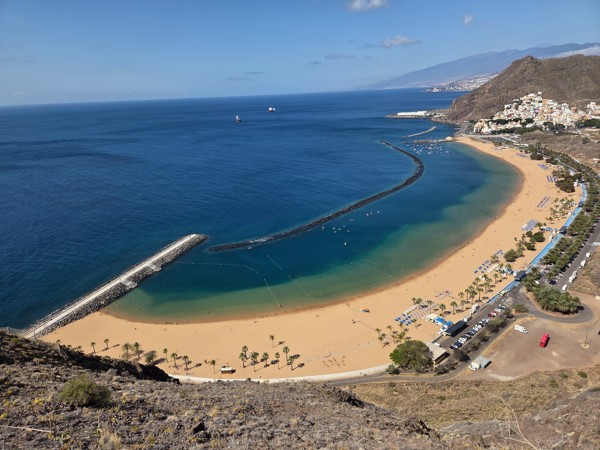 Panoramic view of Las Teresitas beach near Santa Cruz de Tenerife with golden sand, breakwaters and the village of San Andrés along the bay.