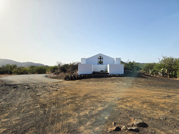 Small white roadside chapel known as the Ermita del Santo Ángel set above a bend in the track near Santiago del Teide.