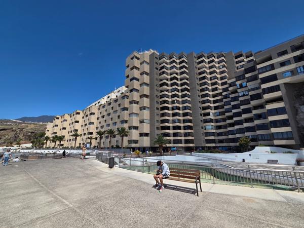 Terraced beige buildings on the seafront