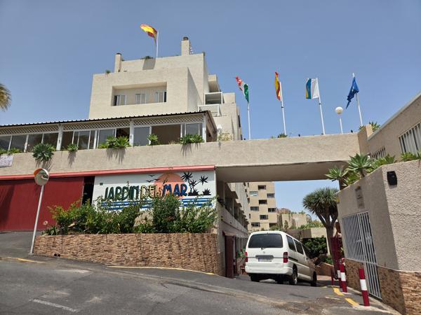 Facade of Jardín del Mar complex with trees and balconies