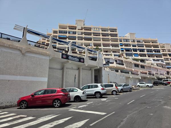 Street view with Oasis restaurant and cars parked