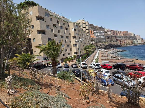 Seafront road with cars parked and modern flats