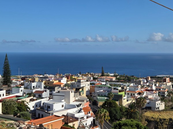 Colorful rooftops of Tejina with the Atlantic beyond, seen from an elevated viewpoint.