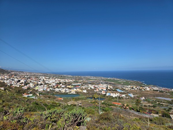 Wide panoramic view over Tejina and the coastal plain stretching to the Atlantic Ocean.