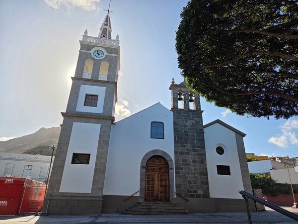Front facade of the Church of San Bartolomé in Tejina with clock tower and bell tower.